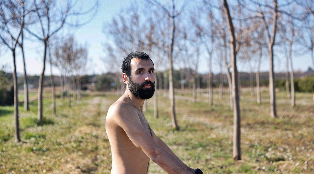 Alejandro Colomar poses naked in his vegetable garden, as Spanish court has ruled in favour of allowing him to continue walking around his village naked, as he has been doing since 2020, in Aldaia, near Valencia, Spain, Feb. 3, 2023. (Reuters)
