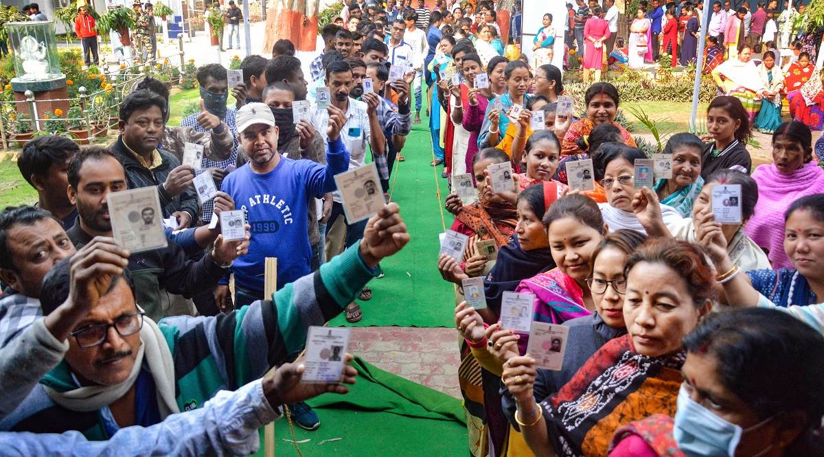 Voters show their identification cards as they wait in queues to cast their votes at a polling booth during the Tripura Assembly elections in Rajnagar. (PTI)