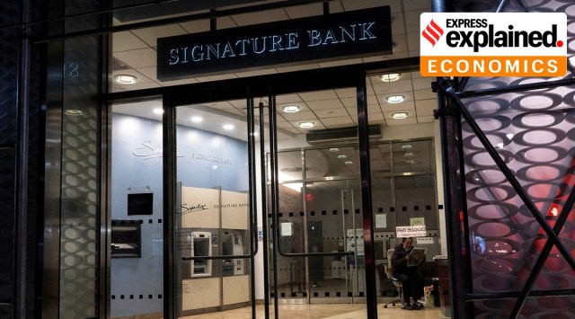 A security worker reads a newspaper inside of one the Signature Bank branches in New York City, U.S., March 12, 2023.