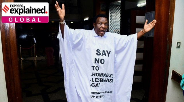 Member of Parliament John Musira dressed in an anti-gay gown gestures as he leaves the chambers during the debate of the Anti-Homosexuality bill, which proposes tough new penalties for same-sex relations, in Kampala, Uganda March 21, 2023. His gown reads: "Say no to *homosexuality *lesbianism *gay".