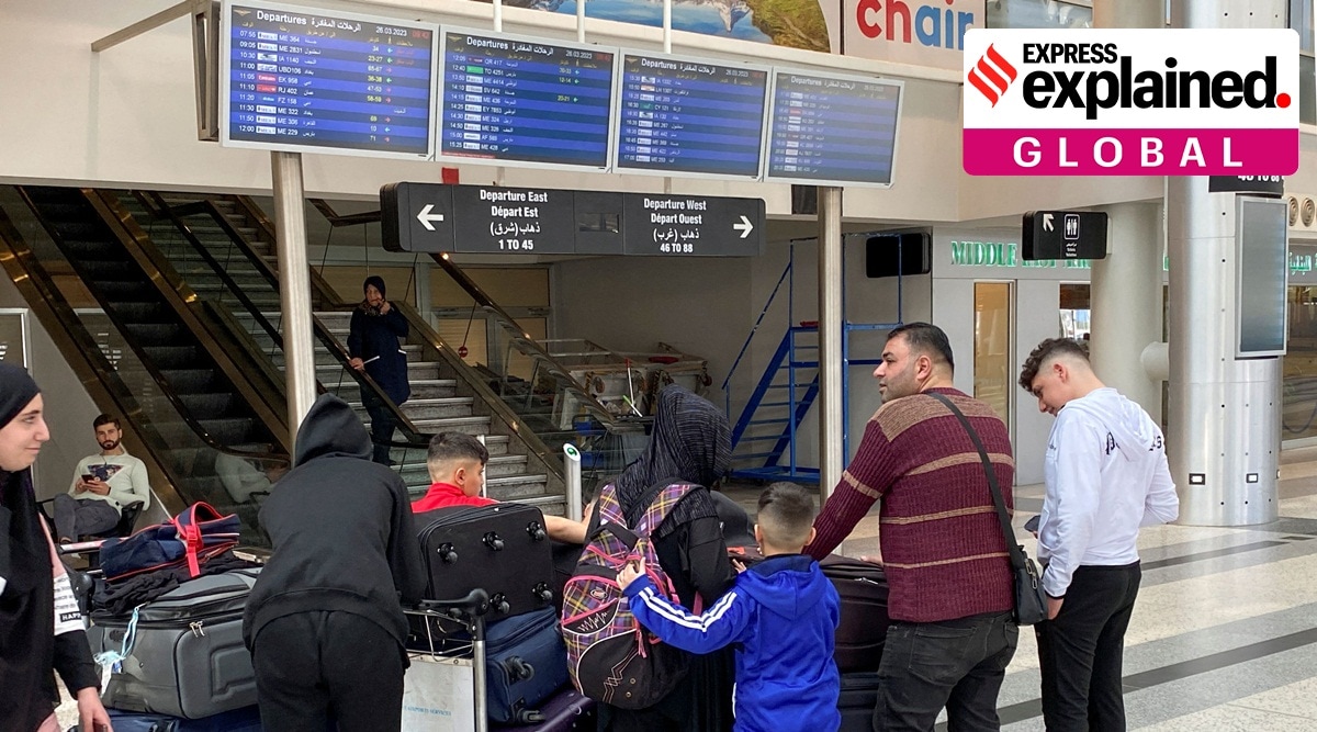 People gather near a departures board, amid a dispute between political and religious authorities over a decision to extend winter time, at Beirut International Airport, Lebanon March 26, 2023.