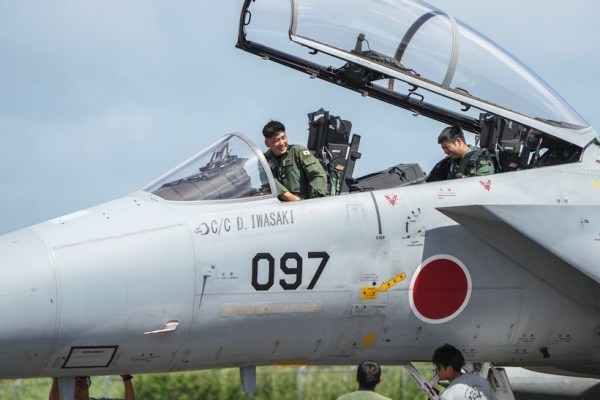 Japanese pilots refuele a F-15 fighter jet at the Tinian airport, on Feb. 17, 2023. (Chang W. Lee/The New York Times)