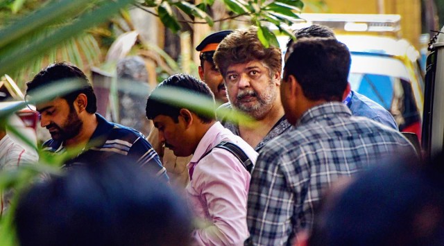 Alleged bookie Anil Jaisinghani being taken to custody after a court remanded him to police custody till March 27 in a case related to alleged attempt to blackmail and bribe Amruta Fadnavis, wife of Maharashtra Deputy CM Devendra Fadnavis, in Mumbai, March 21, 2023. (PTI)