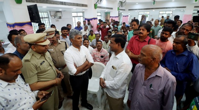 Bihar Rural Development Secretary Balamurugan and SP, special task force, Santosh Kumar, with migrant workers from Bihar in Chennai on Tuesday. (ANI)