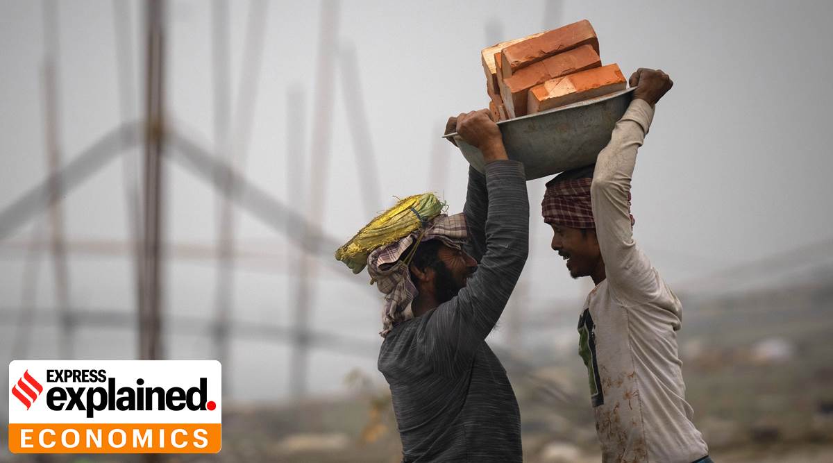 Laborers share a light moment as they carry bricks to be transported in a boat, in Guwahati, Tuesday, Feb. 21, 2023. (AP Photo/Anupam Nath)