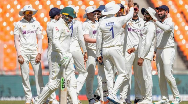 Indian players celebrate dismissal of Australia's Usman Khawaja, foreground, during the second day of the fourth cricket test match between India and Australia in Ahmedabad, India, Friday, March 10, 2023. (AP Photo/Ajit Solanki)