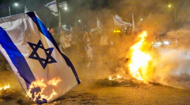 Anti-government protestors burn tires near Beit Yanai, Israel, Monday, March 27, 2023. Tens of thousands Israelis protest against Prime Minister Benjamin Netanyahu's judicial overhaul plan. (AP Photo/Ariel Schalit)