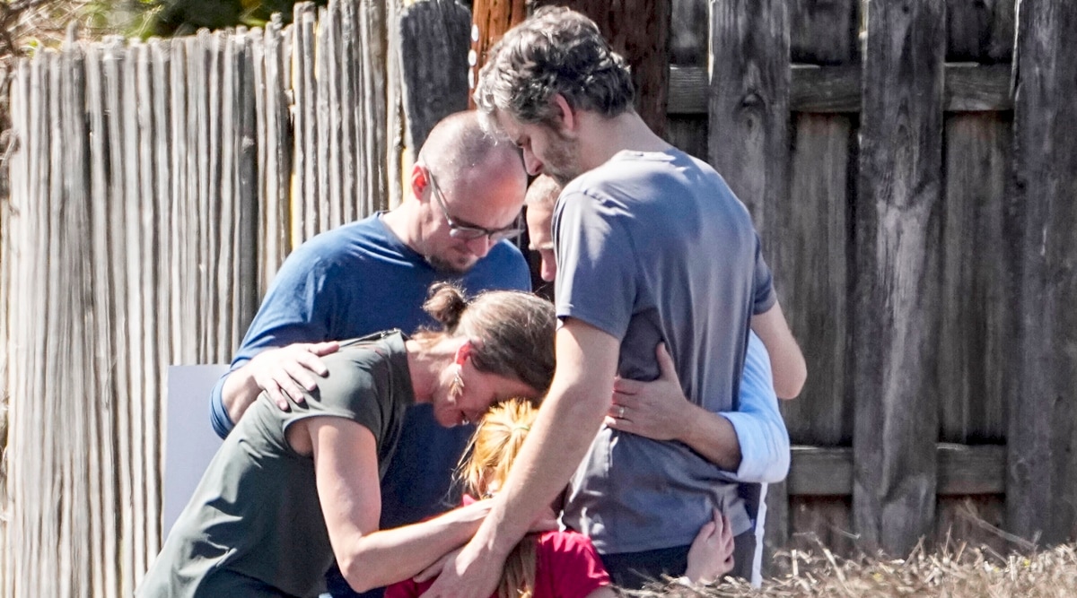 A group prays with a child outside the reunification center at the Woodmont Baptist church after a school shooting, March 27, 2023, in Nashville, Tennessee. (AP)
