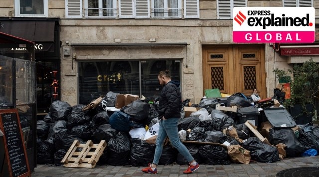 A man walks past uncollected garbage in Paris, Monday, March 13, 2023. The City of Light is losing its luster with tonnes of garbage piling up.