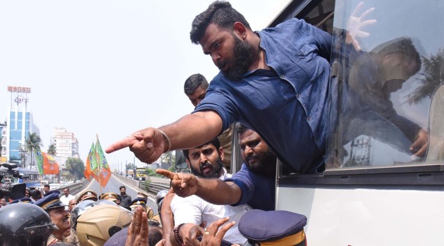 Police detain Yuva Morcha supporters during a protest demanding safety against toxic fumes emanating from plastic waste of Brahmapuram garbage plant, in Kochi, Monday. (PTI)