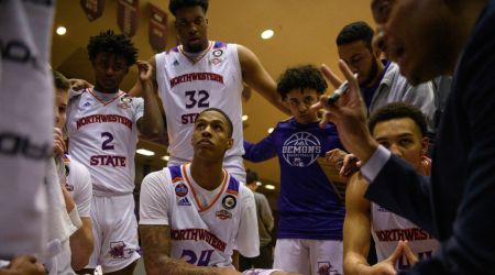 Hansel Enmanuel, a guard at Northwestern State University, huddles with his teammates to listen to their coach during a timeout in a basketball game against the University of New Orleans at Prather Coliseum in Natchitoches, La., on Feb. 18, 2023. Enmanuel has won the respect of his teammates — and his opponents. (Callaghan O'Hare/The New York Times)