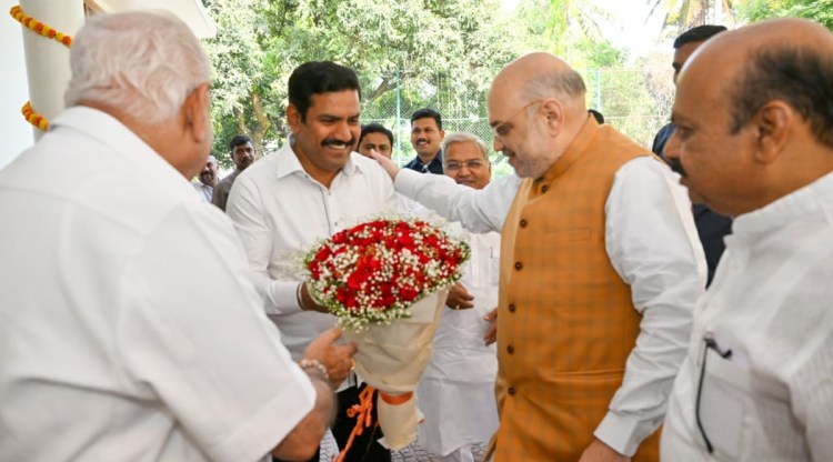 Union Home Minister Amit Shah with former Karnataka CM B S Yediyurappa and his son B Y Vijayendra