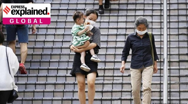 Japanese women and a child walking down stairs.