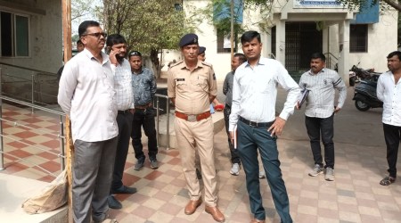 Policemen outside the post-mortem room at Rajkot civil hospital. (Express photo)