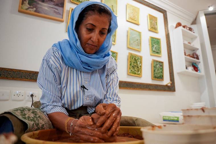 Awatif Al-Keneibit, a Saudi artist, moulds clay making the base of sculptures in her studio where she shows an art-form previously frowned upon in the country but now gaining more acceptance, in Riyadh, Saudi Arabia. (Pic source: Reuters)