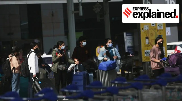 Indian travelers at the entry checkpoint of an airport.