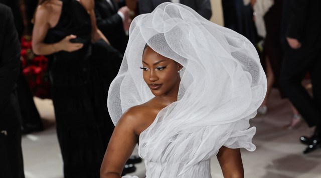 Tems poses on the champagne-colored red carpet during the Oscars arrivals at the 95th Academy Awards in Hollywood (Source: Reuters)
