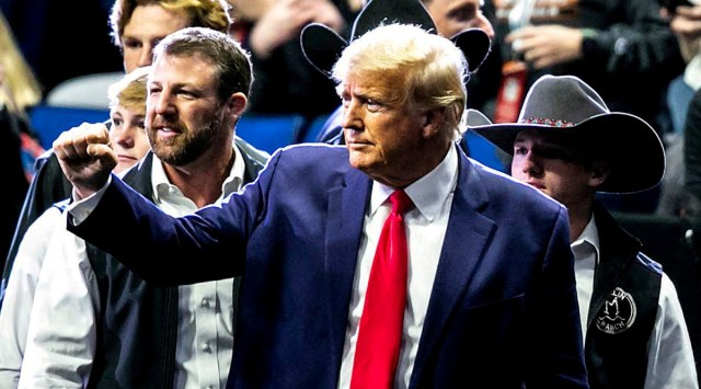 Former President Donald Trump greets fans as he arrives at NCAA Wrestling Championships