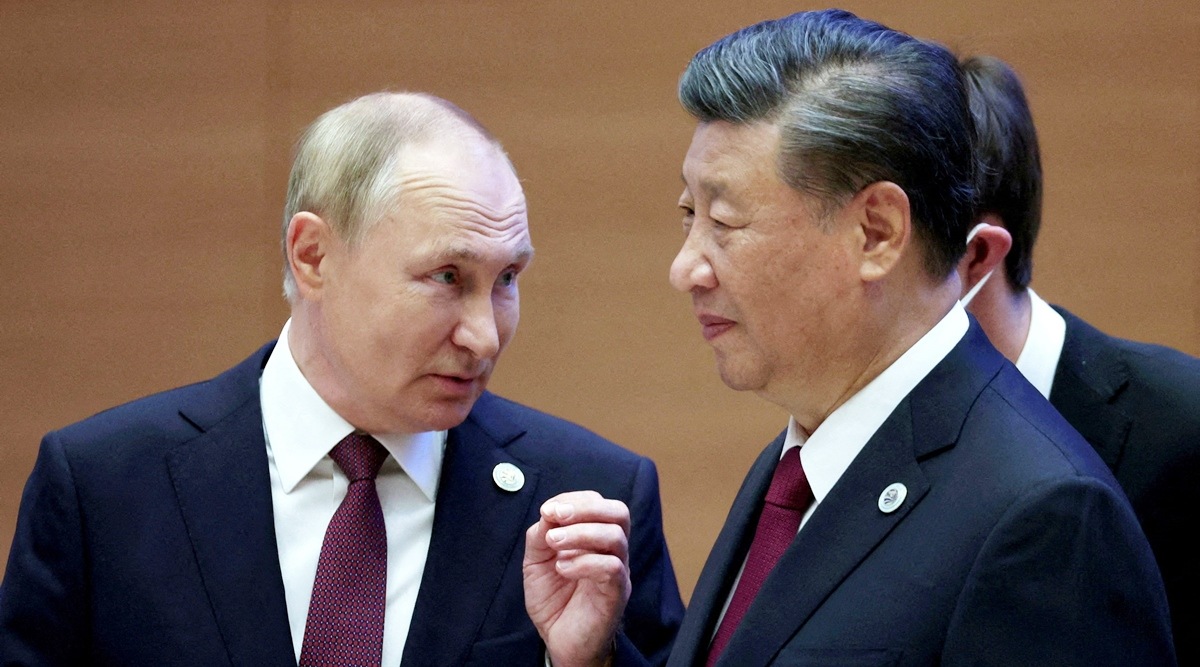 Russian President Vladimir Putin speaks with Chinese President Xi Jinping.