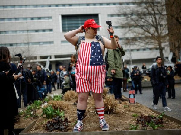 A supporter of former U.S. President Donald Trump demonstrates outside Manhattan Criminal Courthouse on the day of Trump's planned court appearance after his indictment by a Manhattan grand jury following a probe into hush money paid to porn star Stormy Daniels, in New York City, U.S., April 4, 2023. REUTERS/Amanda Perobelli     TPX IMAGES OF THE DAY