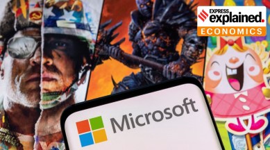 The Microsoft logo is seen on a smartphone placed on displayed Activision Blizzard's games characters in this illustration taken January 18, 2022.