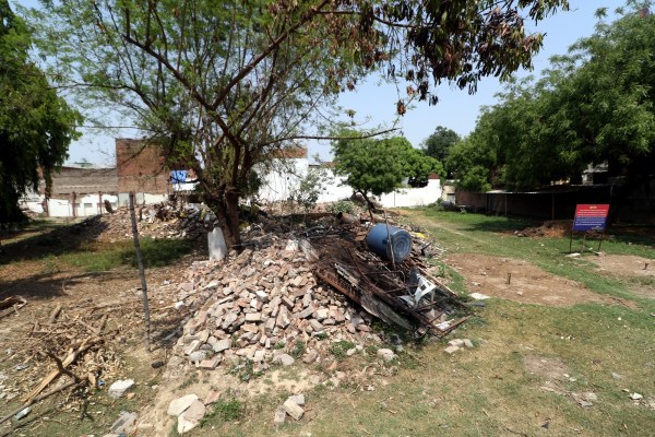 Atiq Ahmad's relatives and associates outside demolished residence in Prayagraj. Express photo by Vishal Srivastav