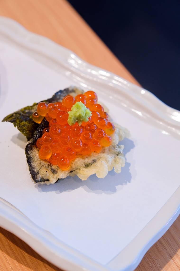 Salmon roe nested on roasted seaweed at the Oshio Tempura and Wine Bar in Tokyo on March 13, 2023. (Andrew Faulk/The New York Times)