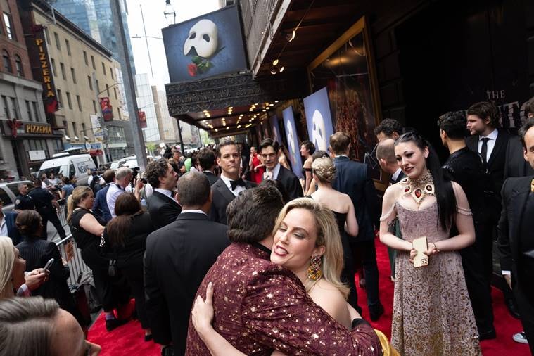 Carlton Moe, obscured, hugs Raquel Suarez Groen before they go on the red carpet for the final performance of ÒThe Phantom of the OperaÓ at the Majestic Theater in New York on Sunday, April 16, 2023. (Sara Krulwich/The New York Times)