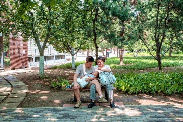 A couple with a baby in a park in Beijing, on June 12, 2022. 