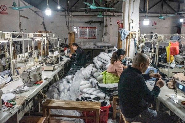 Workers at Guangzhou Basin Clothing Factory, in Guangzhou, China, on Dec. 28, 2022. (Gilles Sabrié/The New York Times)
