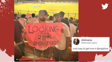 Fans hold placard requesting house on rent during RCB game