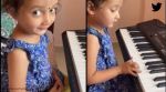 Little girl plays piano as woman sings Kannada song