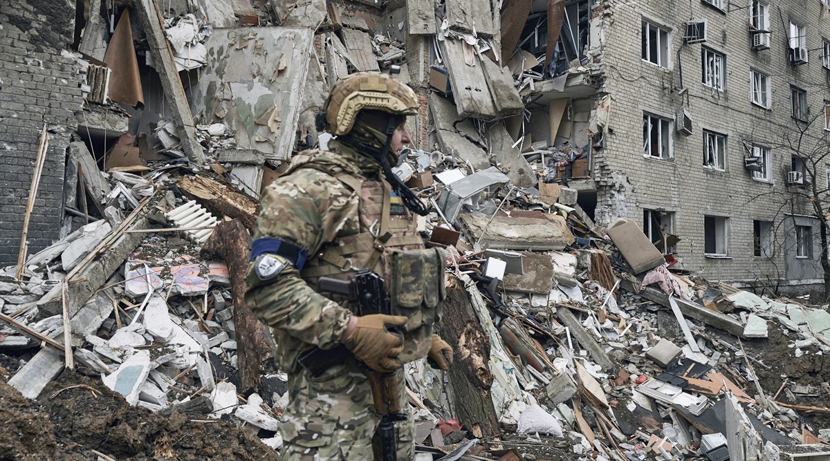 A Ukrainian soldier stands near an apartment building damaged by the recent Russian shelling in war-hit Avdiivka, Donetsk region, Ukraine, April 12, 2023. (AP)