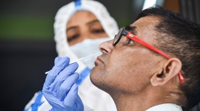 A healthcare worker collects a swab sample of a man for Covid-19 test, amid a rise in coronavirus cases in the country, in New Delhi, April 13, 2023. (PTI)
