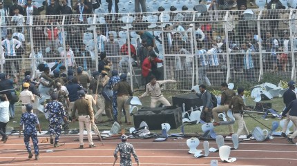 Lionel Messi India GOAT Tour Live Updates: Security forces take cover using broken chairs thrown on the pitch by angry fans at the Salt Lake Stadium pitch after the Argentine football legend left the Kolkata venue in 20 minutes today. (Express Photo by Partha Paul)