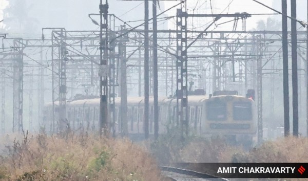 Mumbai local train chugs through a thick layer of smog on January 216, 2023. (Express Photo by Amit Chakravarty)