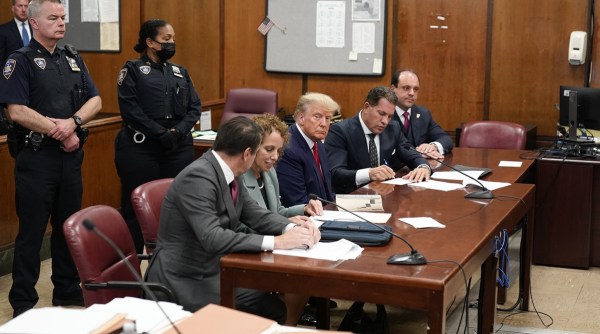 Former President Donald Trump sits at the defense table with his defense team in a Manhattan court, Tuesday, April 4, 2023, in New York. (AP Photo/Seth Wenig)