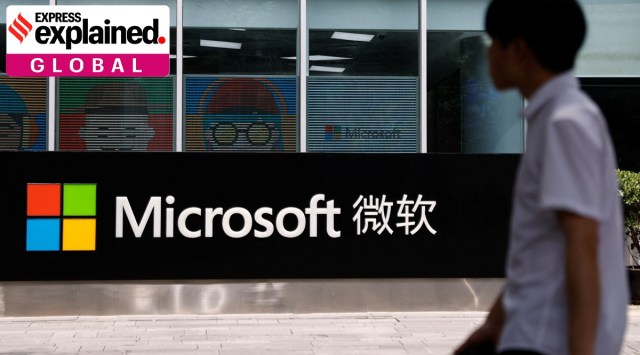 A person walks past a Microsoft sign at its office building in Beijing.