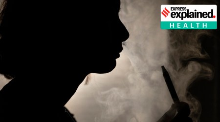 A person poses for a photograph as they vape in Melbourne, March 23, 2023.