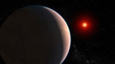 exoplanet with water illustrated orbiting a red dwarf star