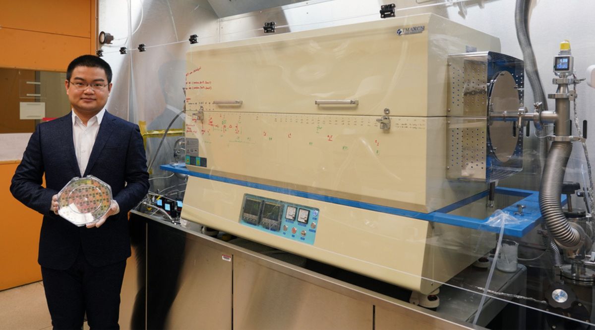 MIT graduate student holding a silicon wafer