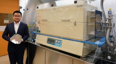 MIT graduate student holding a silicon wafer