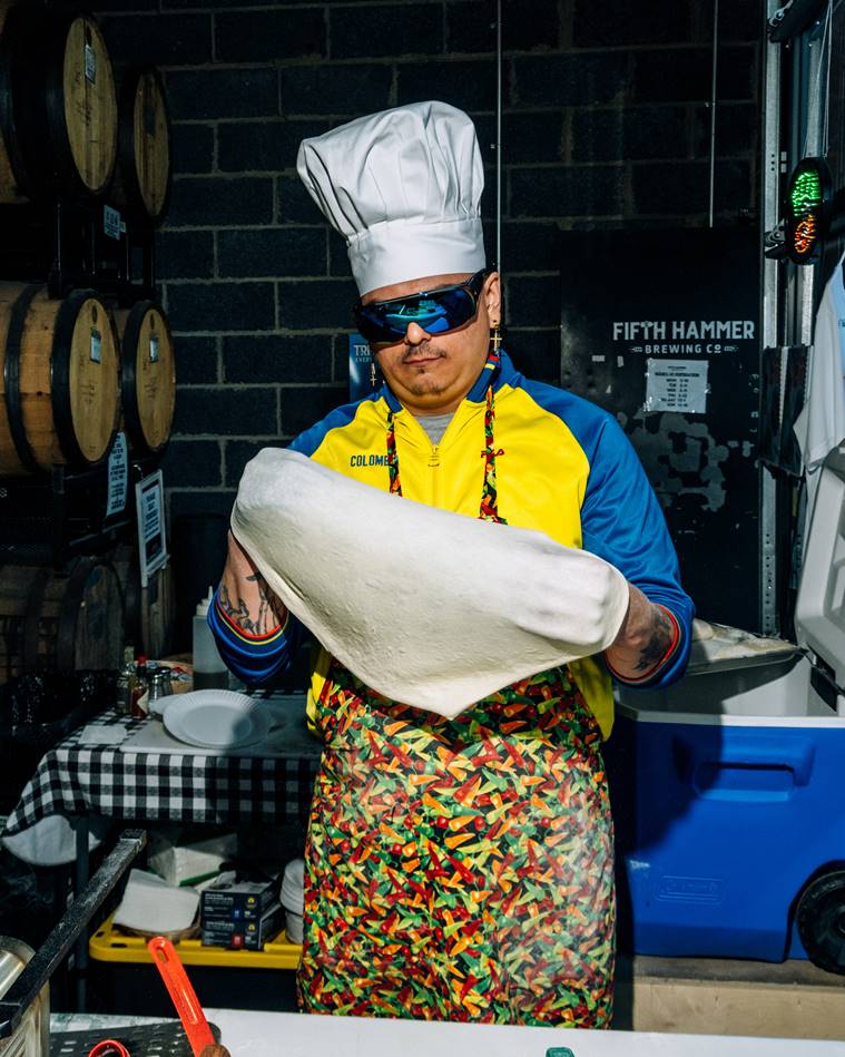 Felix Toro, the founder of Happy Bull, makes a pizza during a pop-up at Fifth Hammer Brewing in Queens, April 18, 2023. (DeSean McClinton-Holland/The New York Times)