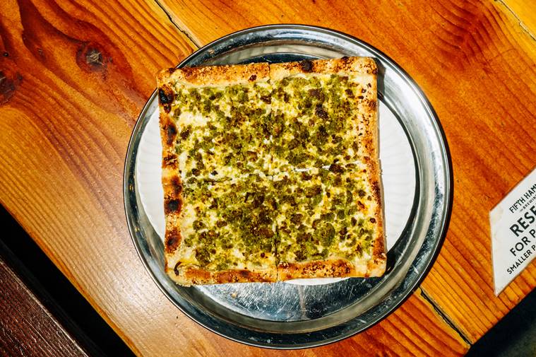 An Egyptian falafel pizza with a sesame-seed crust served at a Traze pop-up inside Fifth Hammer Brewing in Queens, April 26, 2023. (DeSean McClinton-Holland/The New York Times)