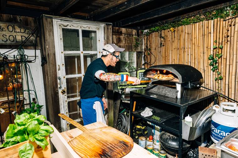 Auggie Russo uses a propane-fueled Ooni oven for his Tiny Pizza Kitchen pop-up in Brooklyn, April 25, 2023. (DeSean McClinton-Holland/The New York Times)