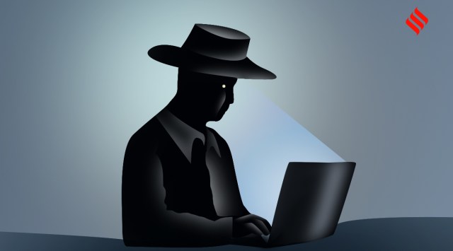 A man staring at a laptop screen in the dark