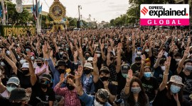 Young protesters flash the three-fingered, anti-government salute at a pro-democracy rally at Democracy Monument in Bangkok, on Aug. 16, 2020. (Adam Dean/The New York Times)
