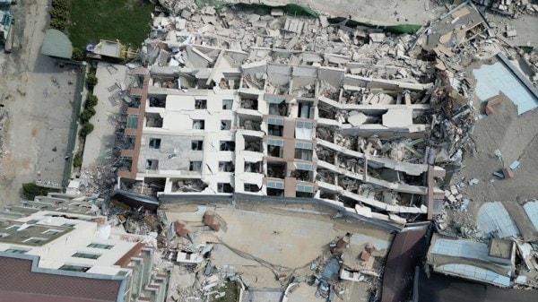 The collapsed Guclu Bahce complex in Antakya, Turkey, March 3, 2023. Turkish families got wealthy off of a construction system rife with patronage — a New York Times investigation reveals just how fatally shaky that system was. (Sergey Ponomarev/The New York Times)