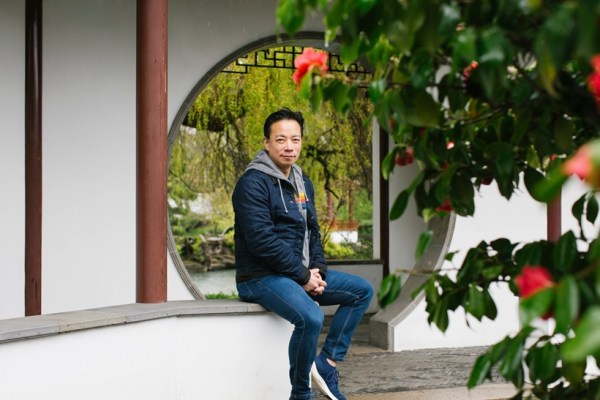 Mayor Ken Sim of Vancouver sits in the Dr. Sun Yat-Sen Classical Chinese Garden in Vancouver’s Chinatown, B.C., Canada, on April 8, 2023. Sim, Vancouver’s first mayor of Chinese descent, rejects claims of Chinese interference and says his landslide win was due to his tireless campaigning and more appealing policies. (Jackie Dives/The New York Times)