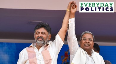 dk shivakumar and siddaramiah joining their hands at the swearing in ceremony in karnataka.